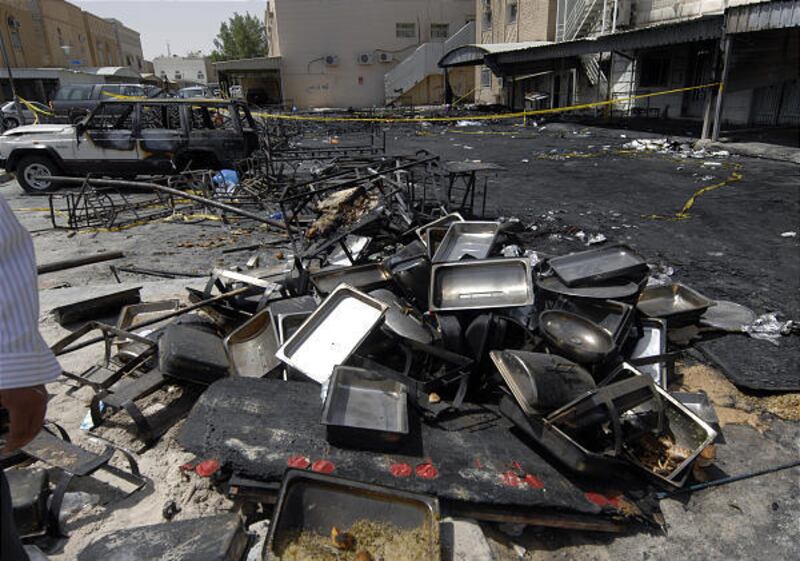 Burned, blackened debris is left after a fire broke out at a wedding tent on Saturday night in Kuwait City, Kuwait.