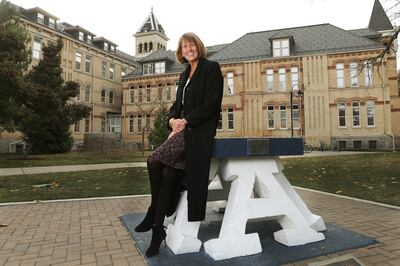 FILE - Utah State University President Noelle Cockett sits on the “block A” on the Logan campus on Nov 8, 2017.