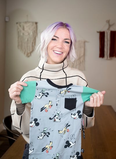 Rachel Nilsson, founder and CEO of children's clothing company Rags, displays one of the rompers that she designed at her home in Highland on Thursday, Nov. 29, 2018.