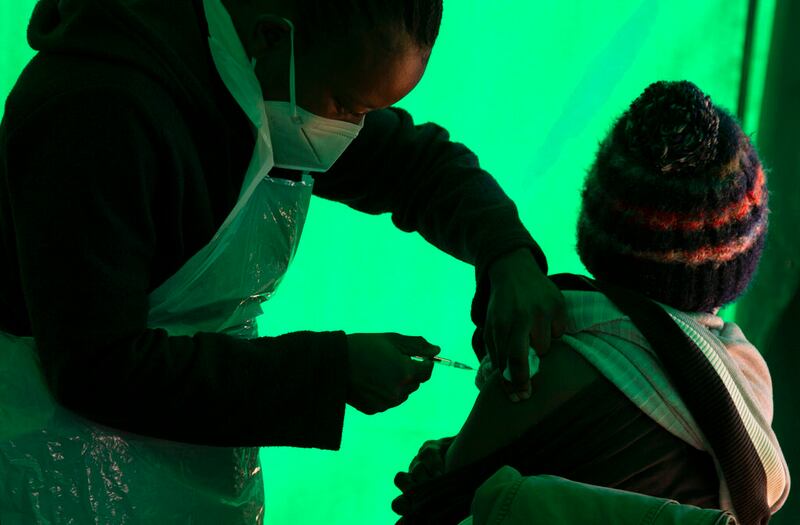 An elderly patient receives a dose of the Pfizer COVID-19 vaccine.