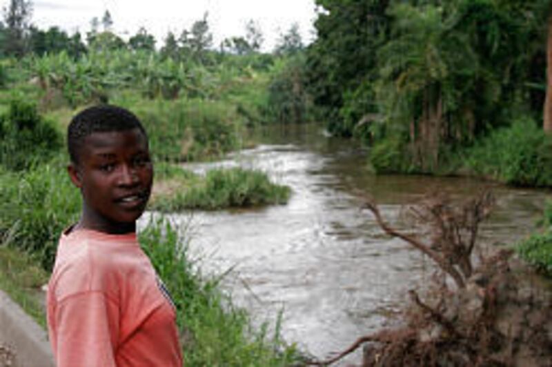 A villager stands near the Rutshuru river that was once the site of a large hippopotamus population, situated at the Virunga National Park close to the town of Rutshuru, Democratic Republic of Congo.