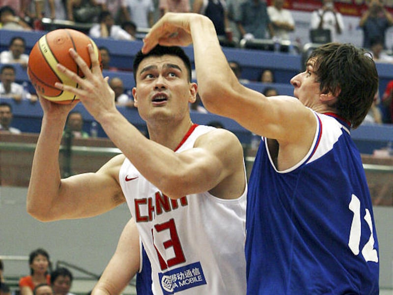Yao Ming (13) puts up a shot against Serbia's Boban Marjanovic (12) in international play Thursday.