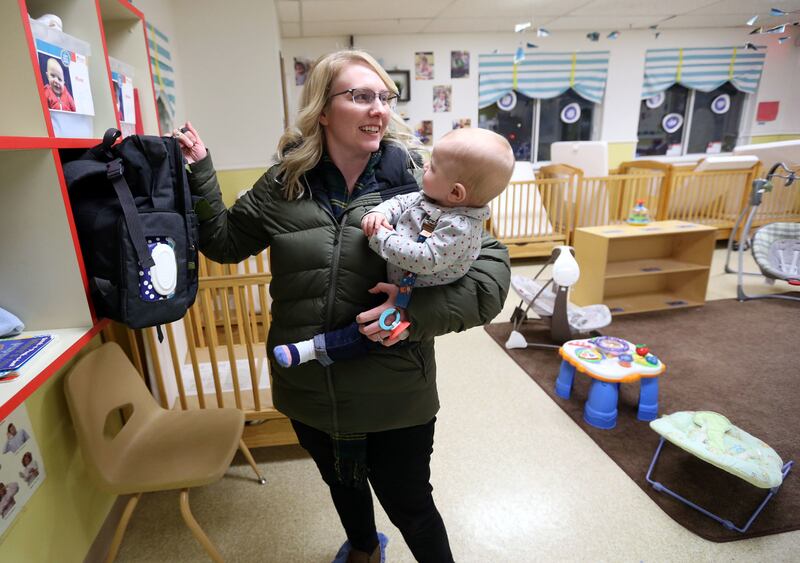 Kelsey Hixson-Bowles picks up her daughter River Hixson-Gray from La Petite Academy of Sandy in Sandy on Friday, Jan. 19, 2018.