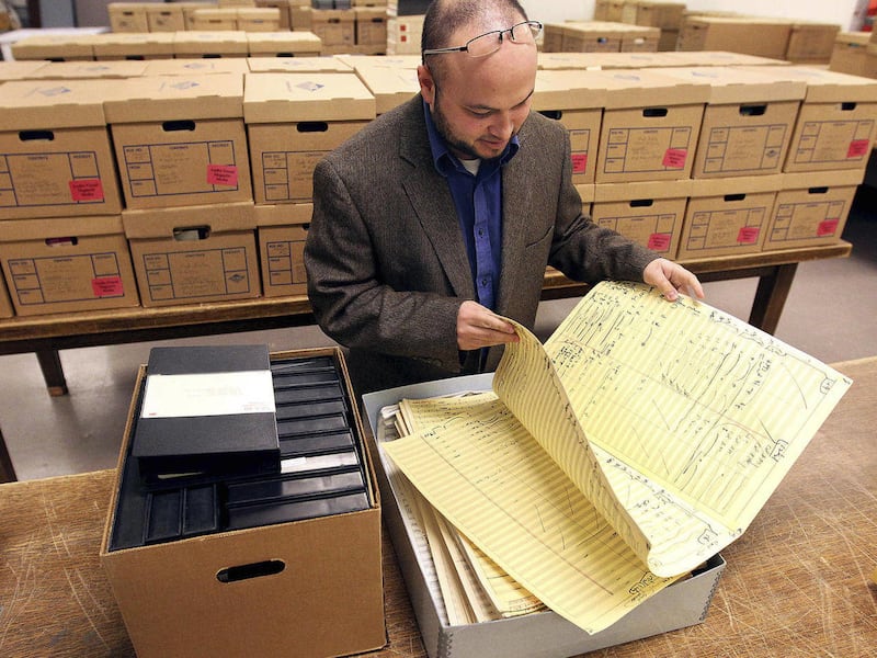 In this Nov. 19, 2010 photo archivist Matthew Francis goes through a collection of Fred Karlin papers inside the Toni Stabile conservation lab at the American Heritage Center in Laramie, Wyo. Francis preserves the history of such events by contacting pol