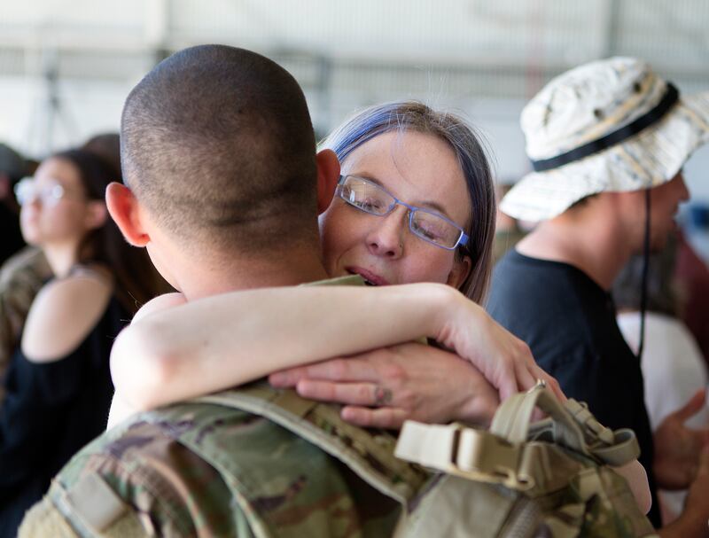 Rayann Estrada hugs Spc. Christopher Estrada of the Utah National Guard before he is deployed to the Middle East at the Roland R. Wright Air National Guard Base in Salt Lake City on Monday, June 4, 2018.