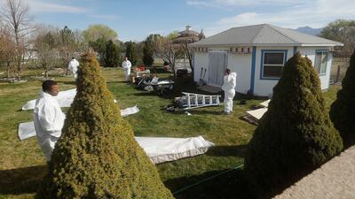 Workers clean out and begin to tear down a pigeon loft in a residential backyard after a four-year legal battle in South Jordan Tuesday, March 31, 2015.