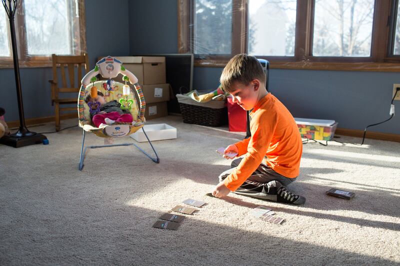 Joey Anderson, 4, lays out cards before playing a game with his mom at their home in Eagan, Minnesota on Saturday, December 15, 2018. Anderson used a parent coach to help improve her relationship with her son.