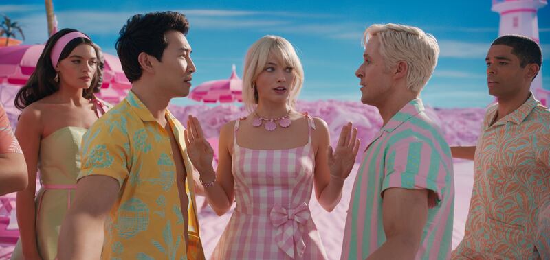 Scene from Barbie the movie, featuring Simu Liu as Ken, Margot Robbie as Barbie, and Ryan Gosling as Ken.
