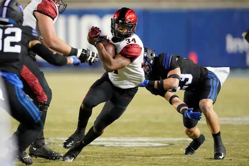 San Diego State’s Greg Bell runs past BYU’s Bracken El-Bakri during game Saturday, Dec. 12, 2020, in Provo, Utah.