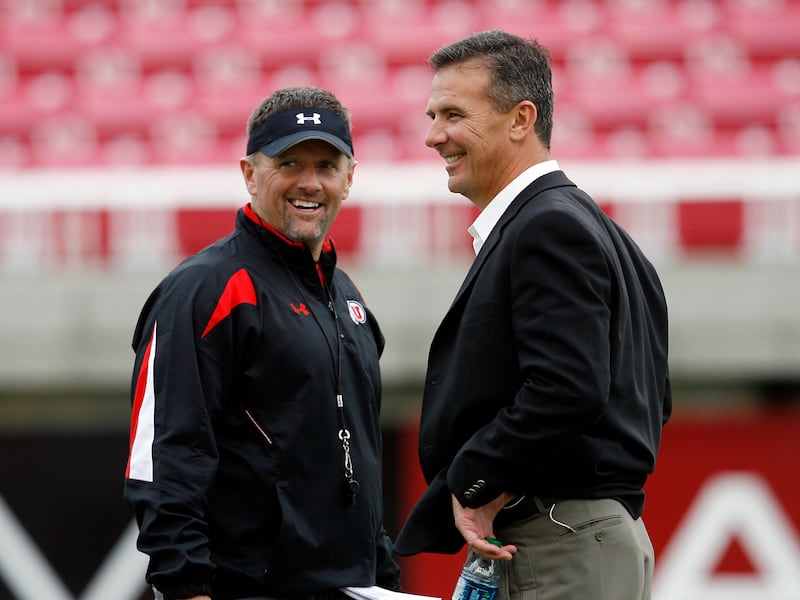 Former Utah coach Urban Meyer, right, talks with Utah coach Kyle Whittingham during a Utah practice at Rice-Eccles Stadium.