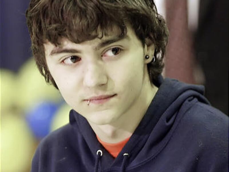 Shawn Hornbeck watches as his parents, Craig and Pam Akers, talk to media in Richwoods, Mo., on Jan. 13, 2007.