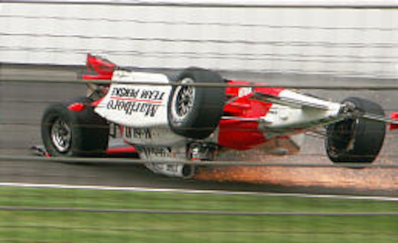 Indy Racing League driver Sam Hornish Jr. slides down the back straight during practice laps on Friday.