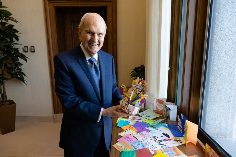 Church President Russell M. Nelson celebrates his 98th birthday admiring cards and letters he received.