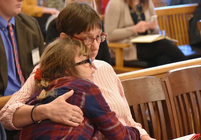 Janice Kopper, of Wichita, Kan., right, hugs her daughter, Ethel, as they follow testimony against a bill designed to protect faith-based adoption agencies from being faced to place children in same-sex households, Wednesday, March 21, 2018, at the Stateh