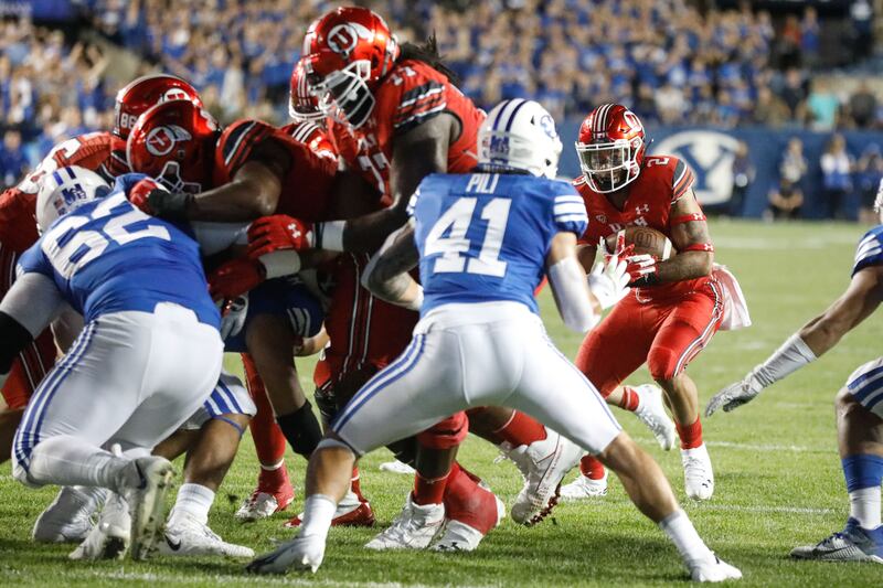 BYU and Utah compete during the first half of an NCAA college football game at LaVell Edwards Stadium in Provo on Saturday, Sept. 11, 2021.