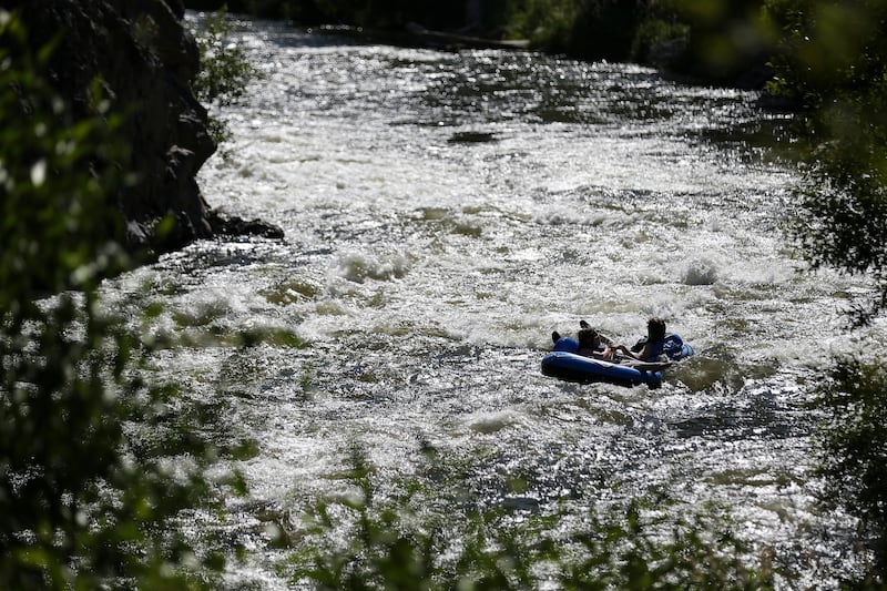 People float on inner tubes down the Weber River near Morgan on Tuesday, July 4, 2017.