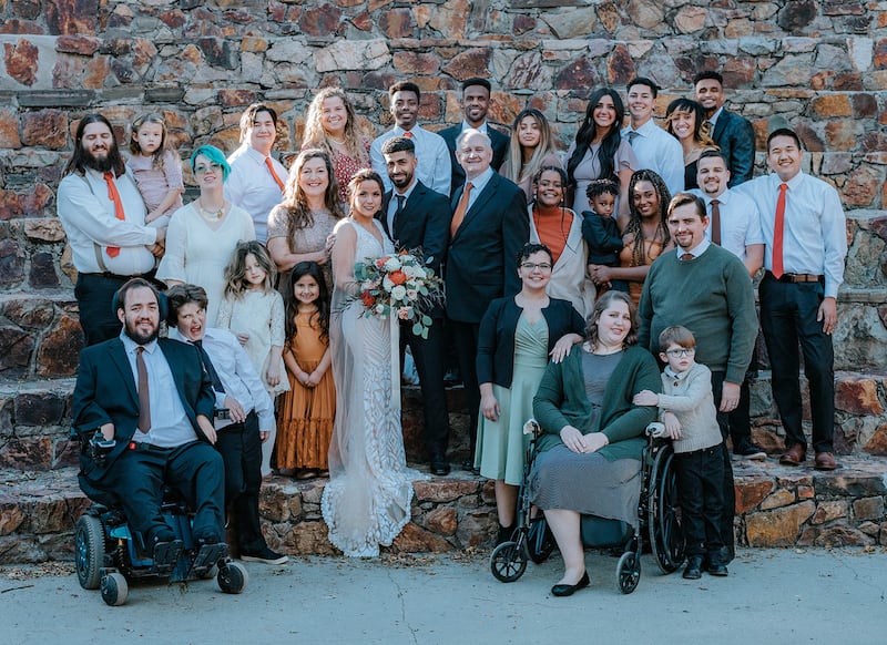 Greg Richardson poses with 15 of his children, their spouses and grandchildren at his daughter’s wedding in October 2021.