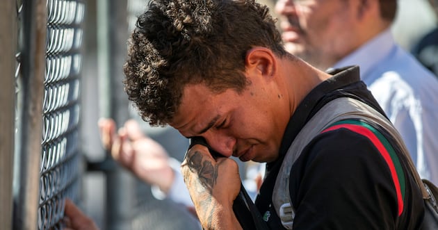 Venezuelan migrant Said Jose wipes his tears while looking for his girlfriend who he was separated from while in detention, at the Sacred Heart Church shelter in El Paso, Texas, Friday, May 12, 2023. The border between the U.S. and Mexico was relatively calm Friday, offering few signs of the chaos that had been feared following a rush by worried migrants to enter the U.S. before the end of pandemic-related immigration restrictions.
