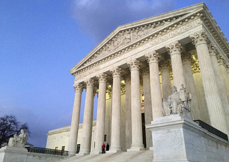 FILE - In this Feb. 13, 2016, file photo, people stand on the steps of the Supreme Court at sunset in Washington.