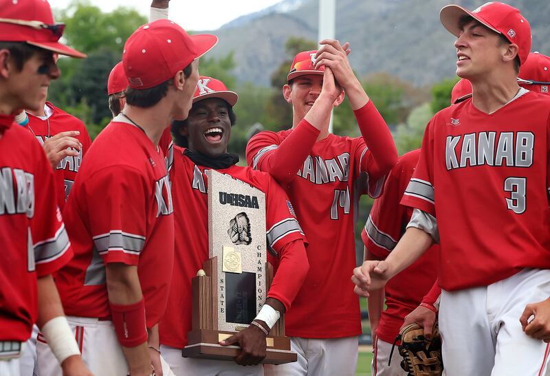 Kanab holds up its 2A state championship trophy