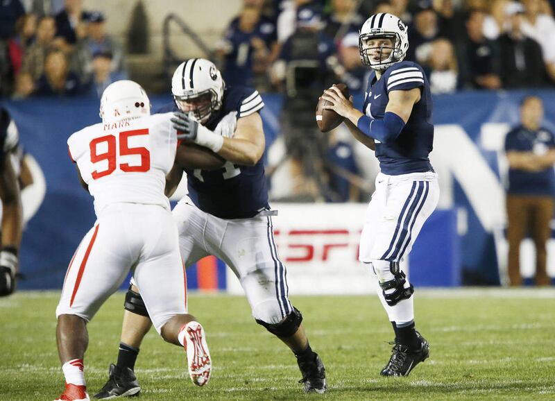 BYU quarterback Taysom Hill (4) throws against Houston in Provo on Thursday, Sept. 11, 2014.