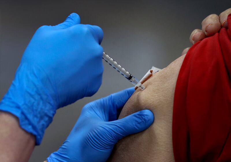 A woman receives a COVID-19 vaccination.
