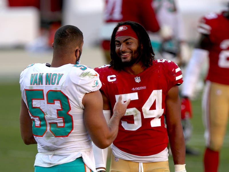 Kyle Van Noy and Fred Warner talk after an NFL football game.