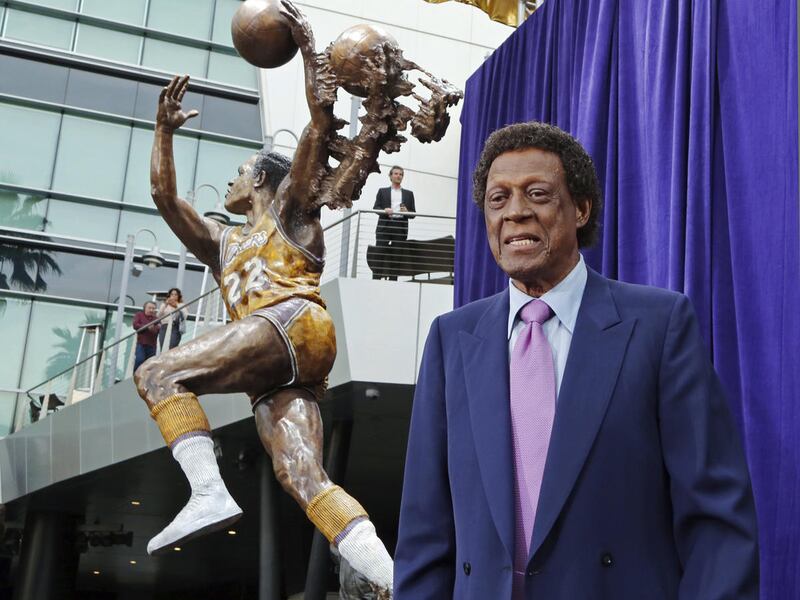 Elgin Baylor stands next to a statue, just unveiled, honoring the Minneapolis and Los Angeles Lakers great, outside Staples Center in Los Angeles on Friday, April 6, 2018.