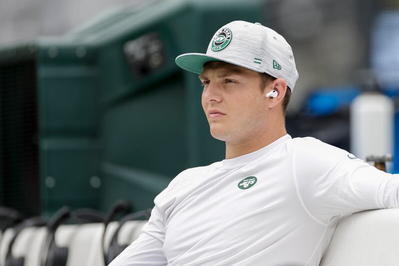 New York Jets quarterback Zach Wilson sits on the bench during practice before a preseason NFL football game against the New York Giants, Sunday, Aug. 28, 2022, in East Rutherford, N.J.