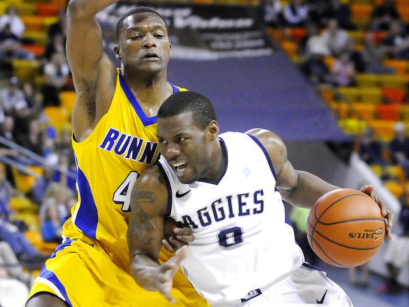 Utah State's Brockeith Pane (0) tries to drive past Cal State Bakersfield's Stephon Carter during the Aggies' win.