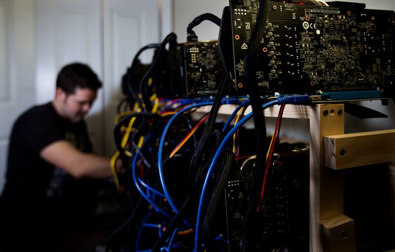 Jacob Berezay adjusts his Ethereum mining setup in South Salt Lake on Thursday, Dec. 28, 2017.