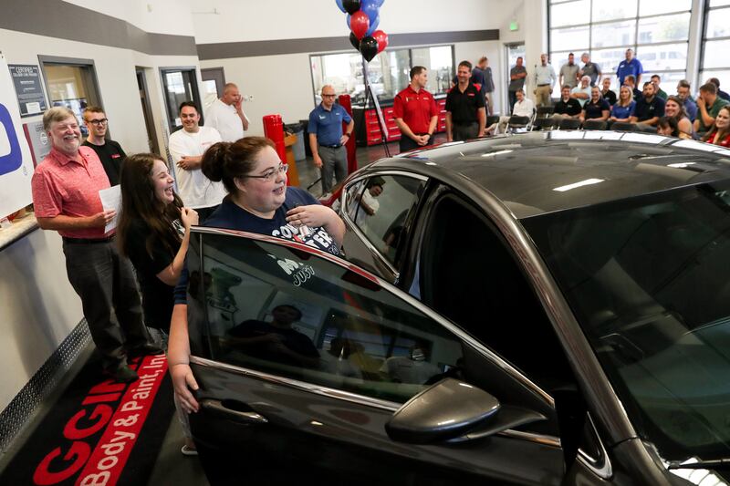 Darlene Lefevre and her daughter, Sophia, 10, react as they get their first glimpse of a 2015 Chrysler 200 that was donated to them at Higgins Body and Paint in West Valley City on Wednesday, June 27, 2018. Geico and Higgins Body and Paint, along with oth