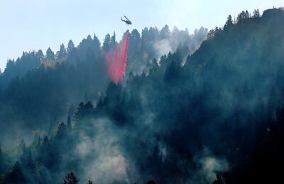 A helicopter drops retardant on the Pole Creek Fire in Woodland Hills on Friday, Sept. 21, 2018.