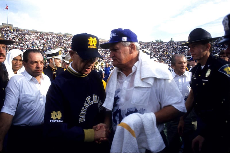 Coaches LaVell Edwards, right, and Lou Holtz shake hands following BYU's win in 1994.