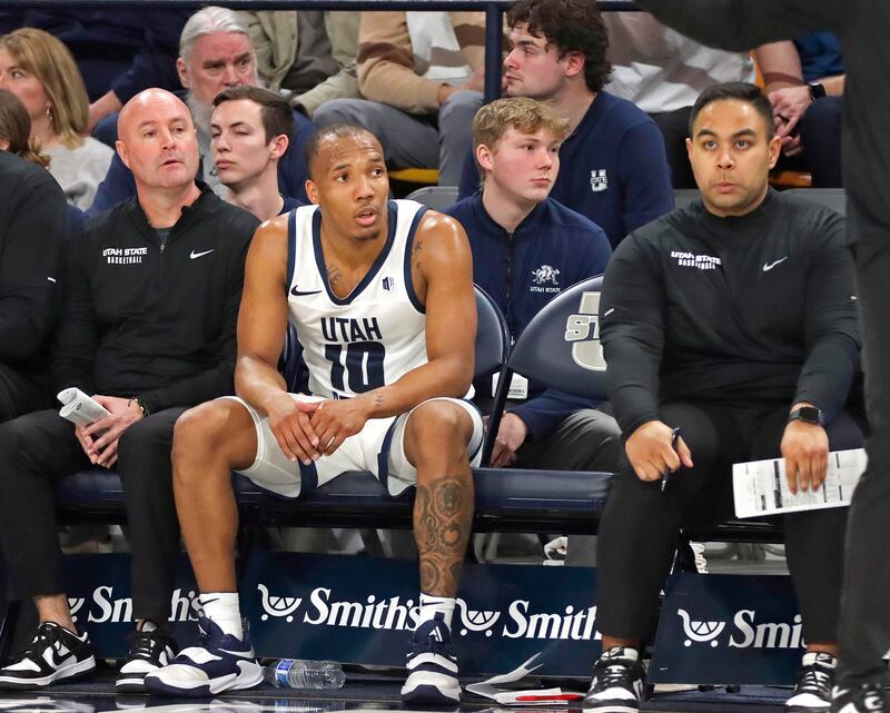 Utah State guard Darius Brown II gets a rare — and very brief — rest during USU’s game against New Mexico last Saturday. The graduate point guard is averaging a Mountain West-high 35.7 minutes per game this season.