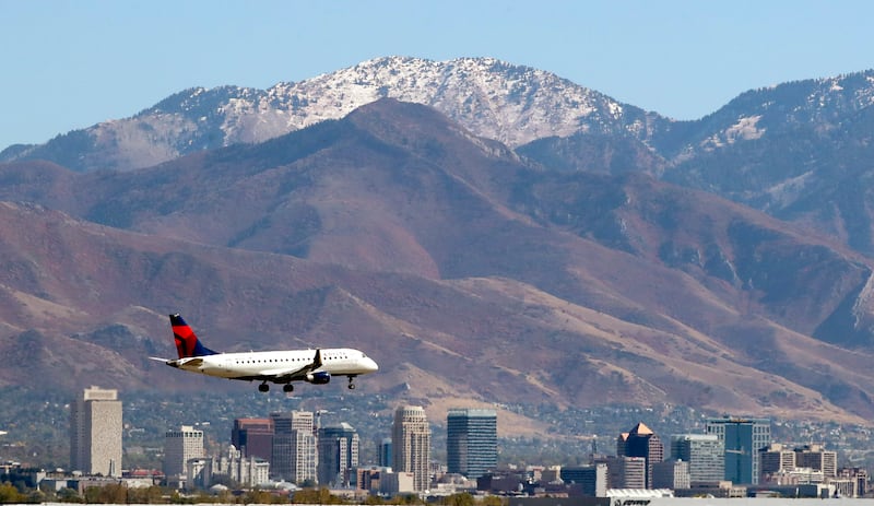 Downtown Salt Lake City and an airplane are pictured on Oct. 12, 2020.