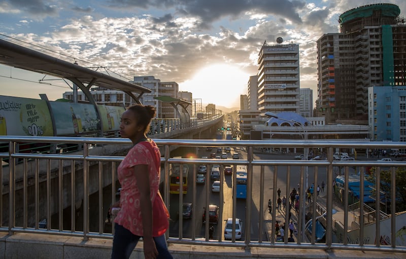 A woman walks on bridge to a station of the city's light railway, in Addis Ababa, Ethiopia Monday, Oct. 10, 2016.