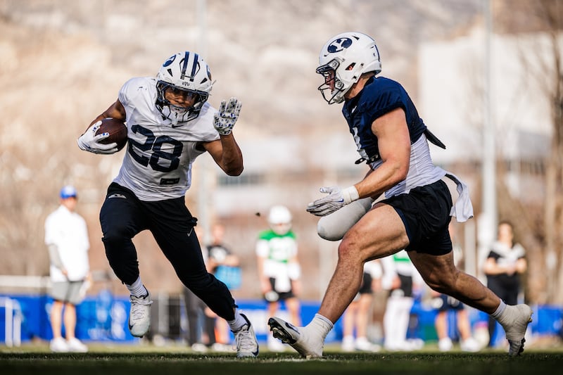 BYU running back Jovesa Damuni carries the ball during practice March 12, 2026.