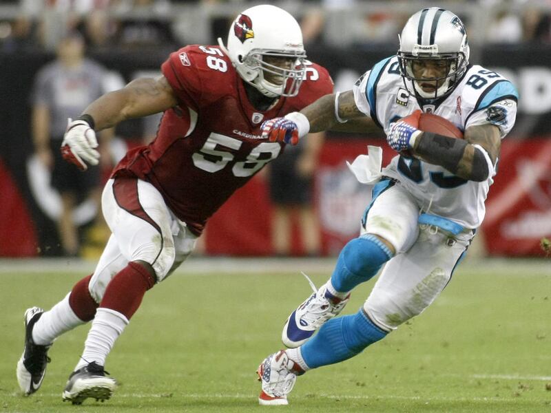 In this photo taken Sept. 11, 2011, Carolina Panthers wide receiver Steve Smith (89) gains yards against Arizona Cardinals linebacker Daryl Washington (58) during the second half of an NFL football game in Glendale, Ariz. The Cardinals won 28-21.
