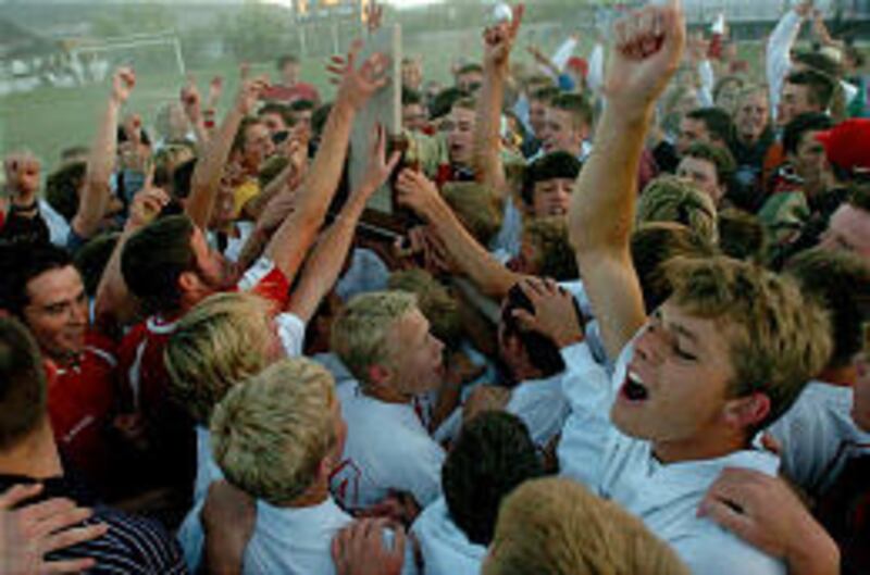 The Weber Warriors celebrate their victory over Brighton in the 5A state championship match.
