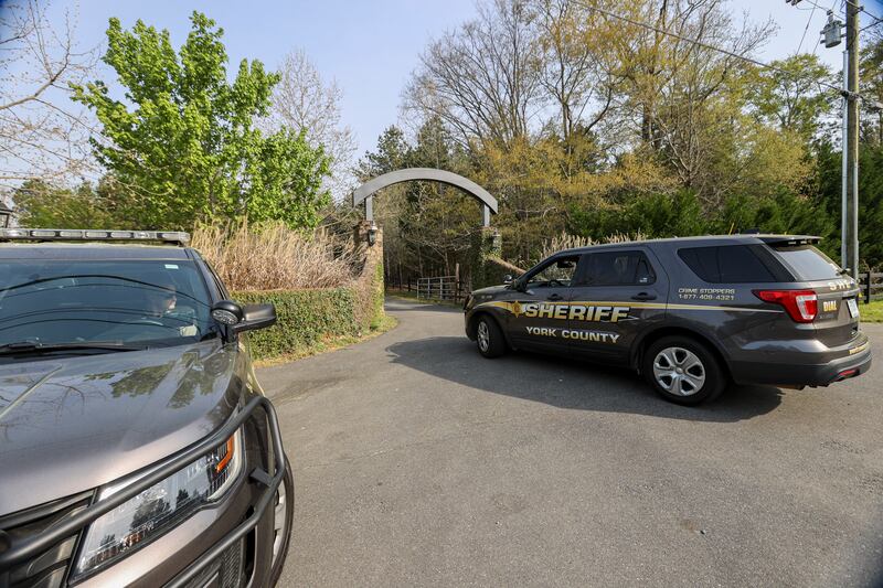 A York County sheriff vehicle drives onto the property where multiple people, including a prominent doctor, were fatally shot a day earlier, Thursday, April 8, 2021, in Rock Hill, S.C.