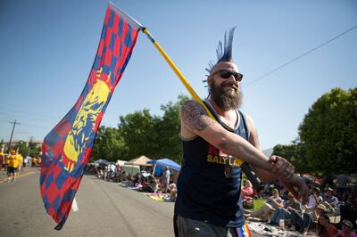 Ryan Terry waves a Real Salt Lake flag during the Days of '47 Parade in Salt Lake City on Tuesday, July 24, 2018.