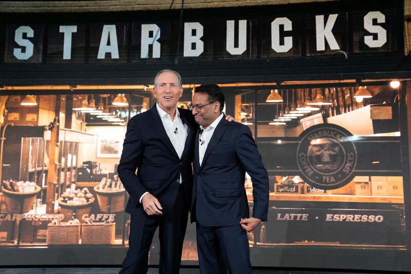 Interim CEO Howard Schultz and incoming CEO Laxman Narasimhan hug during Starbucks Investor Day 2022.