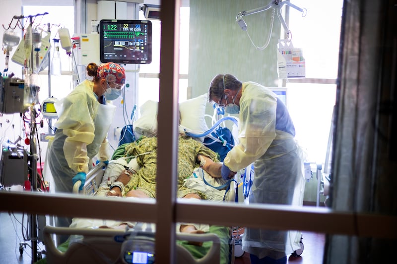 Dr. William Dittrich looks over a COVID-19 patient at St. Luke’s Boise Medical Center in Boise, Idaho, on Aug. 31, 2021. New research has found that unvaccinated people are 20 times more likely to die from the coronavirus.