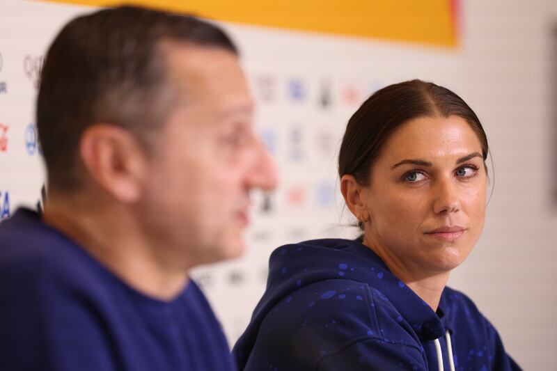 United States’ Alex Morgan looks at coach Vlatko Andonovski during a press conference ahead of their World Cup knockout round