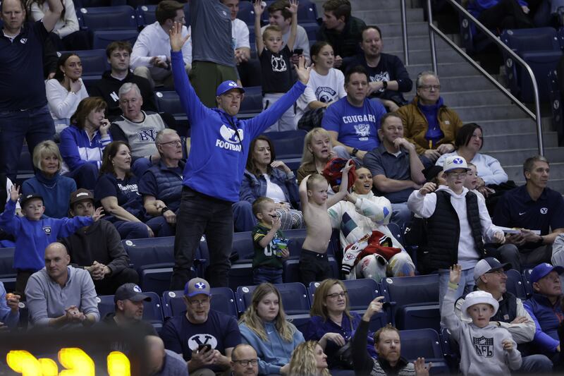 Former BYU Cougars football player Daniel Sorensen (standing) appears at a Cougars men’s basketball game versus the UCF Knights on Tuesday, February 13, 2024, at the Marriott Center in Provo, Utah. Taysom Hill, Jaren Hall and Blake Freeland were also in attendance.