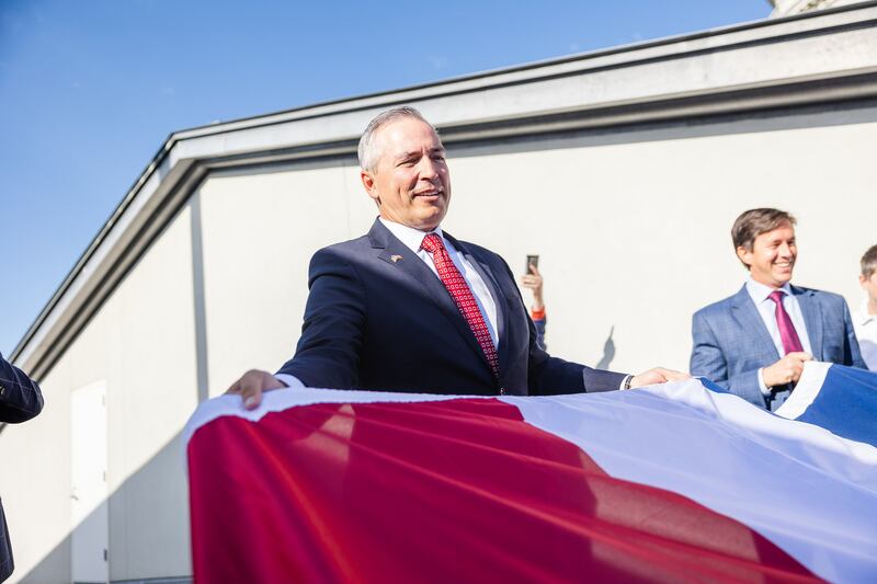 Sen. Dan McCay, R-Riverton, holds the flag during the raising of the new Utah state flag at the Capitol in Salt Lake City on Wednesday.