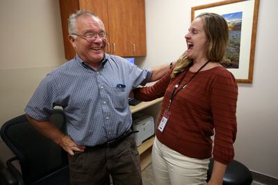Art Eichbauer jokes with physician assistant Meghan Zorn at the end of an appointment to adjust his deep brain stimulator for Parkinson's treatment at the Imaging & Neurosciences Center at the University of Utah on Wednesday, Sept. 12, 2018.