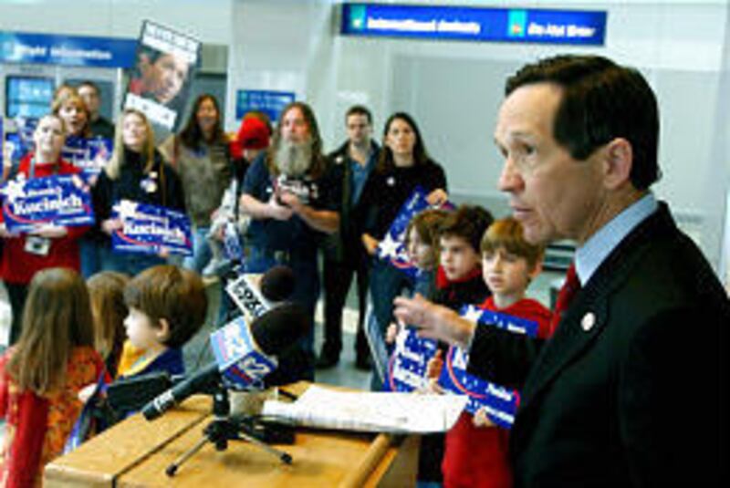 Rep. Dennis Kucinich talks to supporters at the Salt Lake airport.