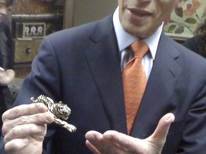 State Treasurer Steven Grossman holds a jewel-encrusted tiger pin at the Statehouse in Boston Wednesday, Oct. 26, 2011. The pin is one of the more unusual items of unclaimed property that the state will be begin auctioning on eBay beginning Saturday.